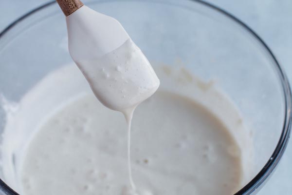 thinner keto icing dripping from a spatula