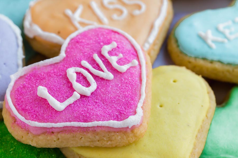 love printed on a pink heart shaped cookie