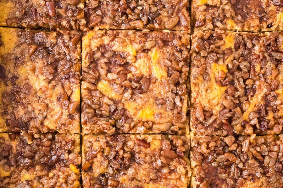 Close-up view of the pecan topping and golden surface of the sliced keto sweet potato casserole, highlighting its texture and cinnamon-sugar appearance.