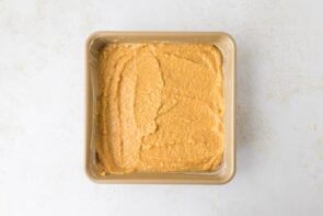 The prepared casserole batter spread evenly in the greased baking dish.