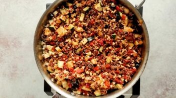 diced up veggies and ground beef cooking in a skillet