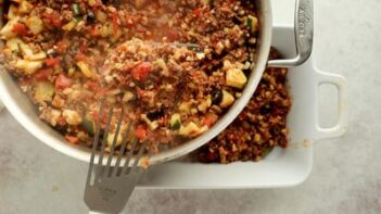 holding up a spoonful of taco mixture with a slotted spatula