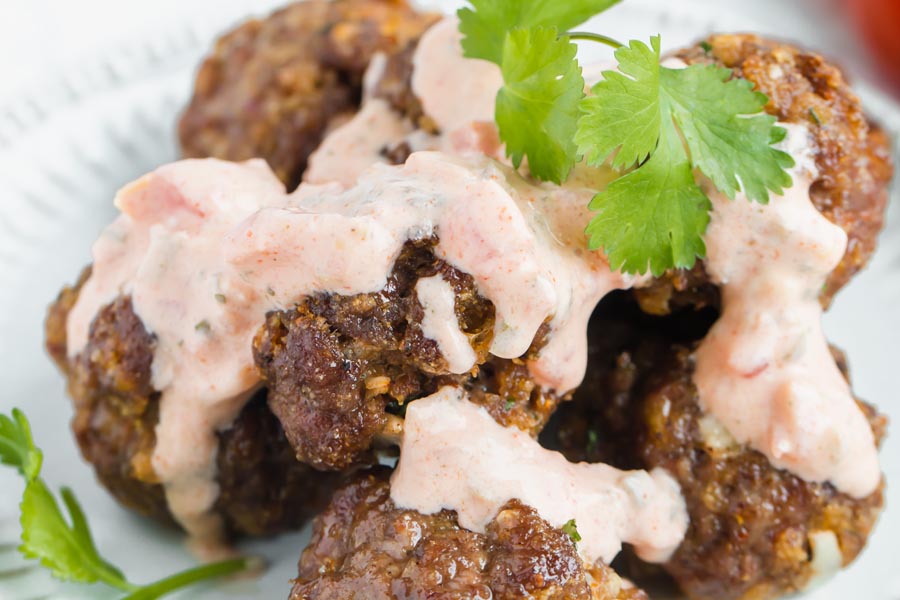 taco meatballs with creamy salsa drizzled on top