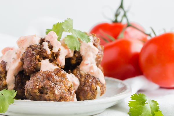 keto taco meatballs on a plate with salsa on top