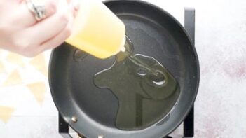 pouring oil into a non-stick skillet