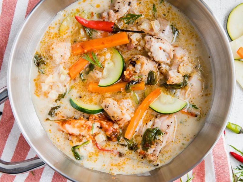 overhead shot of keto thai chicken soup with pieces of chicken