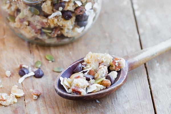 a wooden spoon filled with keto trail mix for hiking or camping