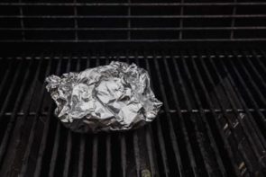 fresh vegetables and chili garlic sauce on a foil pack