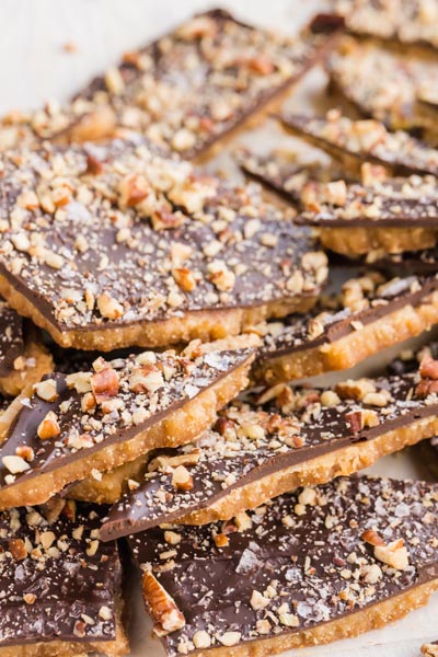 A pile of keto toffee with crushed pecans on top.