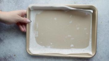 A quarter baking tray lined with parchment paper.
