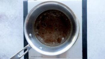 A small saucepan with melted butter and brown sugar inside.