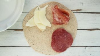 meat and cheese in each corner with a black tortilla square corner