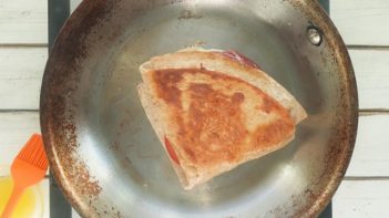 frying a tortilla sandwich in a skillet