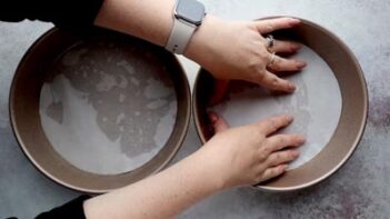 placing a parchment circle inside a cake pan