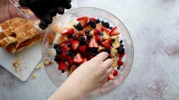 sprinkling berries in a trifle bowl