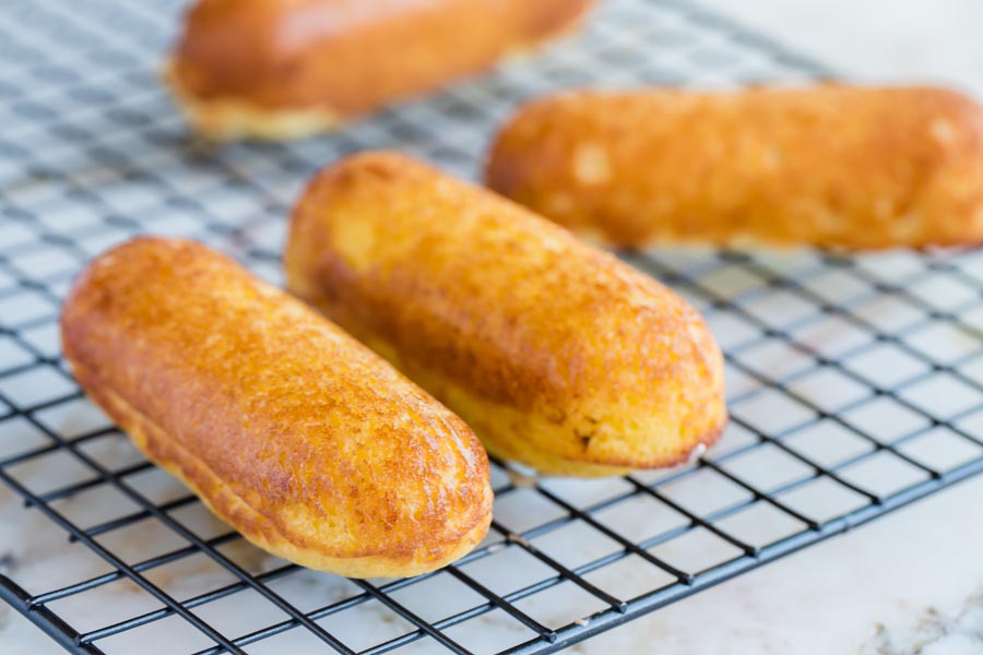 freshly baked twinkies on a wire rack