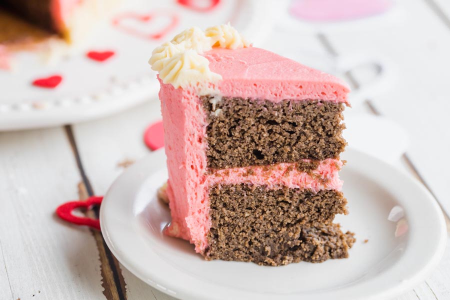 a slice of chocolate cake with pink frosting