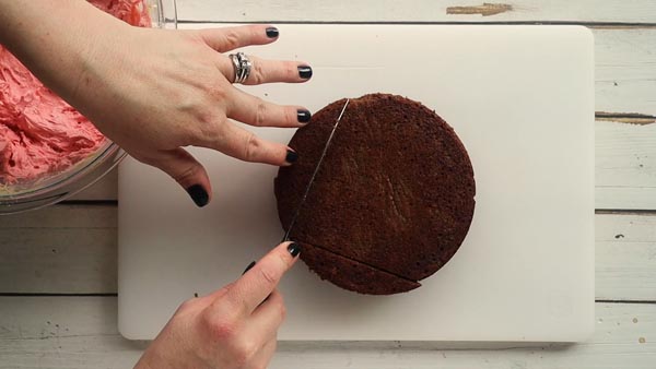 cutting the edges off a chocolate cake