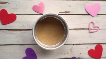 a small cake pan with a parchment circle inside