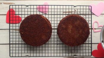 two round chocolate cakes on a wire rack