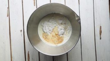 a bowl with cream and powdered sweetener and vanilla