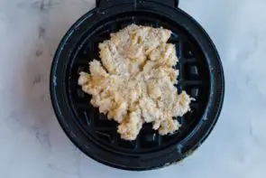 pouring waffle mixture onto the waffle maker