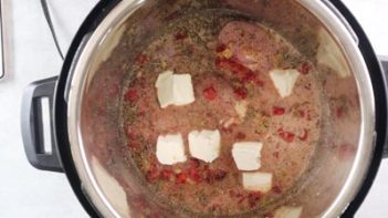 cream cheese cubes spread throughout a keto white chili