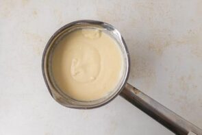 Creamy white enchilada sauce in a saucepan.
