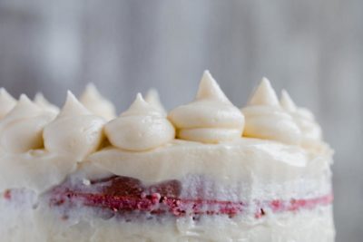 sugar free white chocolate cream cheese frosting decorated on a red velvet cake