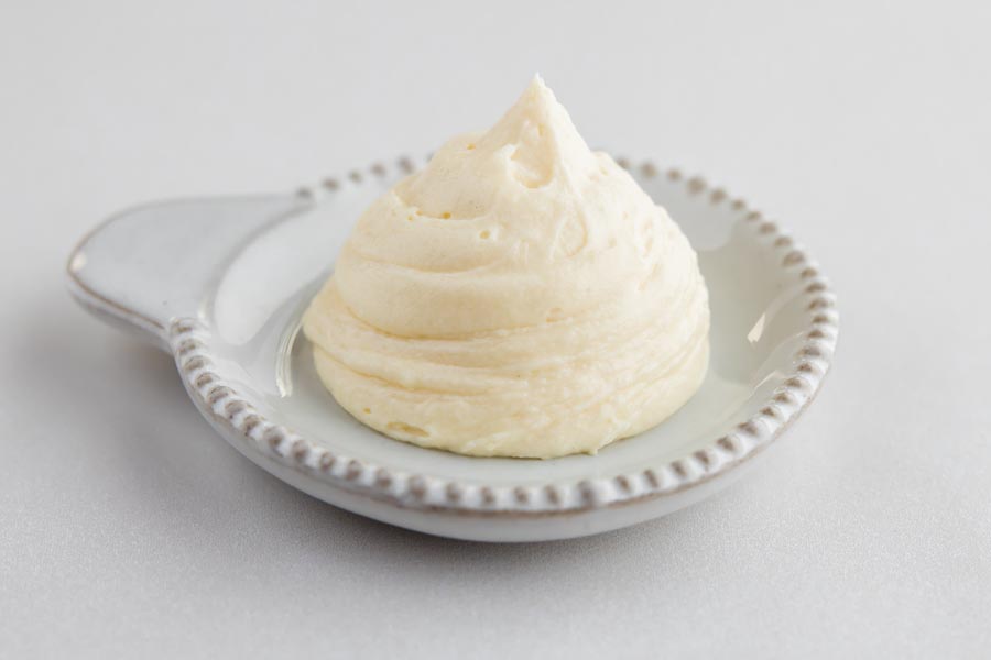 small plate with a dollup of creamy keto cream cheese frosting