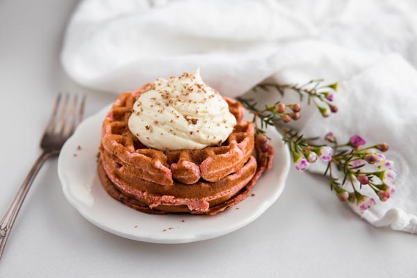 red velvet waffles topped with keto cream cheese frosting