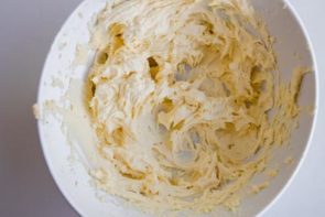 cream cheese and butter beat together until creamy in a white bowl