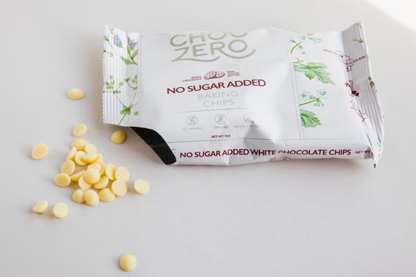 a bag of sugar free white chocolate chips opened with chips on the counter