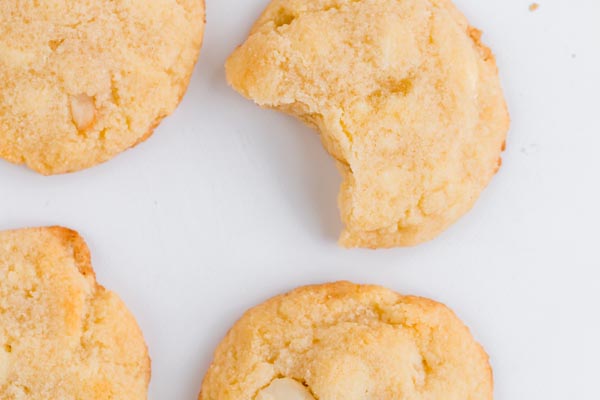 four cookies on a white background one half eaten