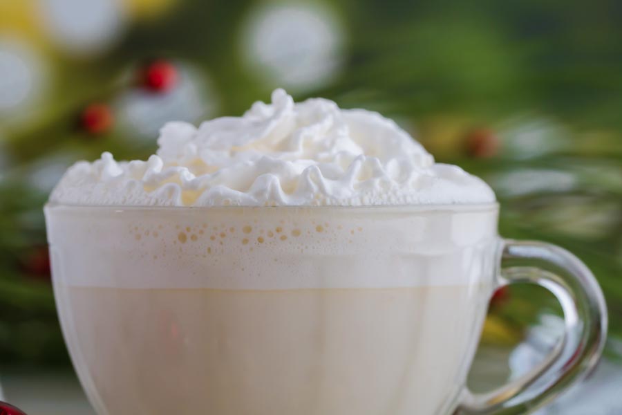 small mug of sugar free white hot cocoa topped with whipped cream