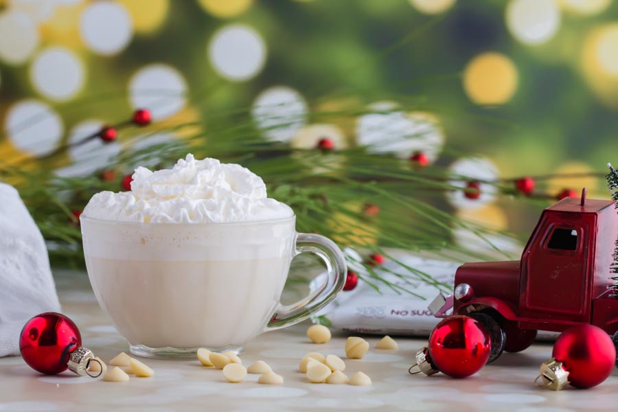 white hot chocolate while decorating christmas tree