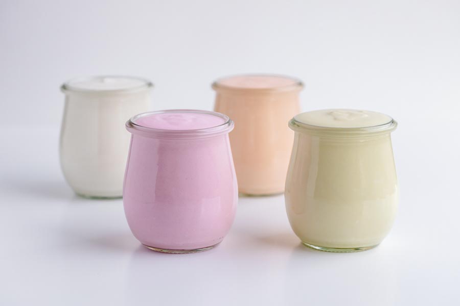 Flour yogurt flavors next to each other in glass jars.