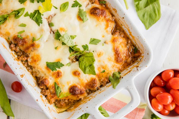 cheesy lasagna casserole with basil on top