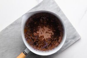 Culinary lavender steeping in hot water in a saucepan to make homemade lavender tea.