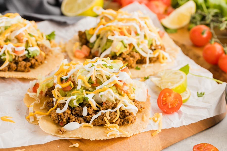 crispy low carb tostada shells topped with beef, cheese and guacamole