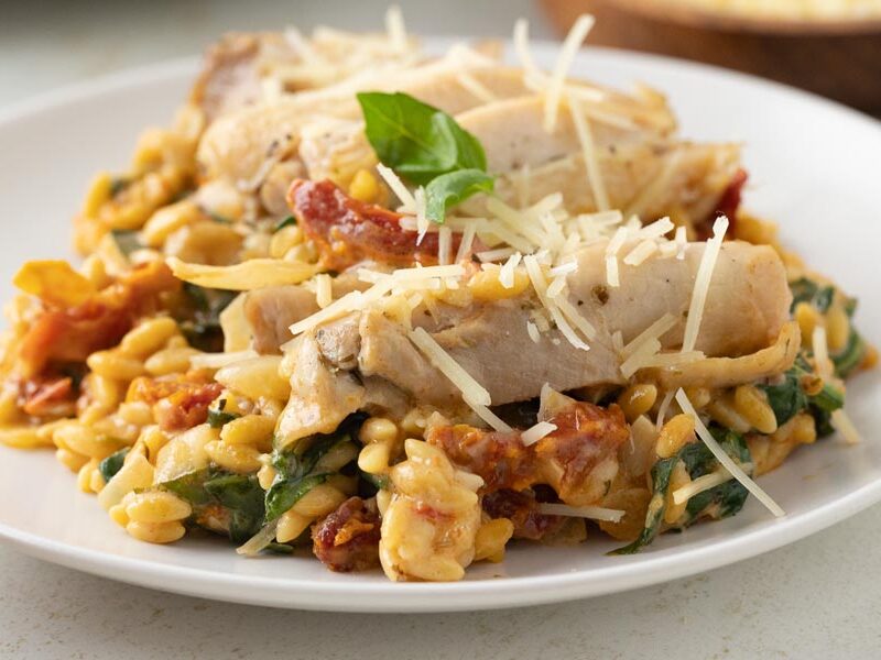 Creamy Tuscan chicken and orzo with spinach, sun-dried tomatoes and parmesan.