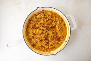 Creamy cooked low carb orzo in a skillet with sun-dried tomato sauce.