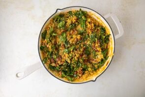 Wilted spinach is mixed into a creamy orzo pasta skillet dish.