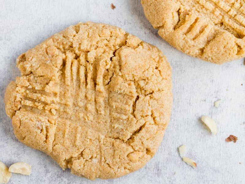 large peanut butter cookie on the counter with another one next to it