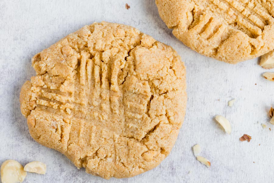 large peanut butter cookie on the counter with another one next to it