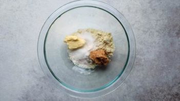 cookie ingredients and peanut butter in a clear bowl