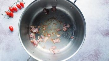 diced bacon cooking in a stock pot