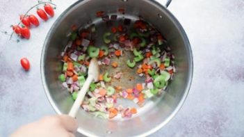 sautéing vegetables in a pot