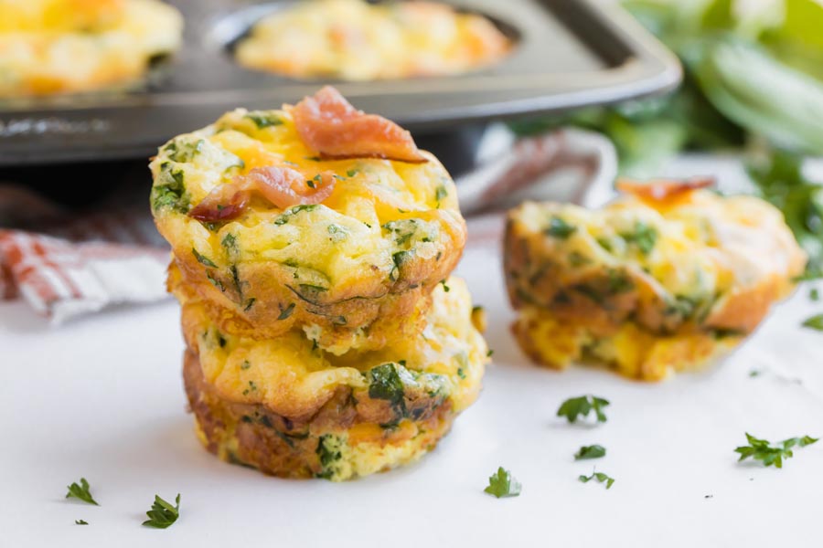 two mini frittatas stacked on each other with parsley sprinkled around