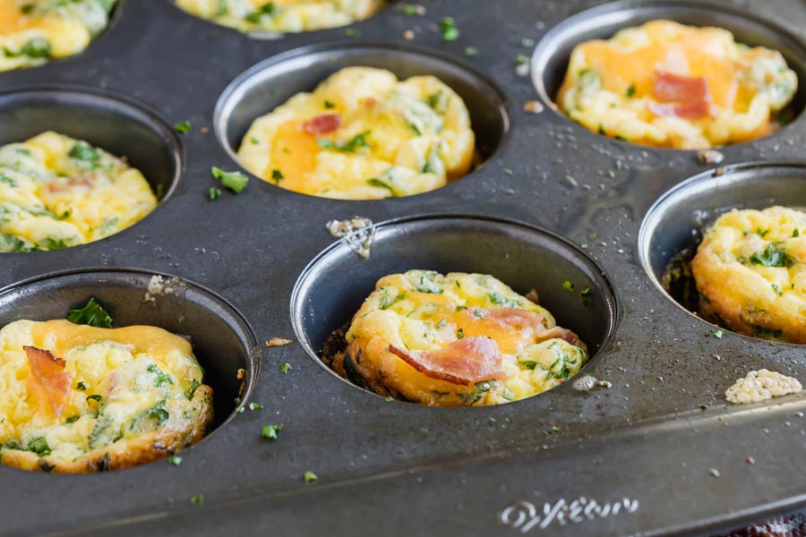 a muffin tin with egg muffins inside